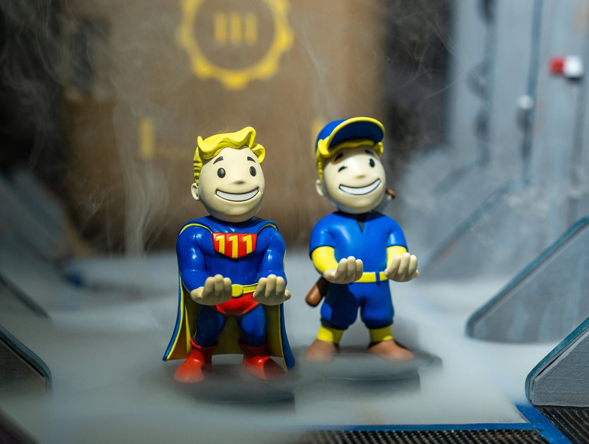 Fallout Mini Cable Guys figurines holding out hands, displayed with misty background
