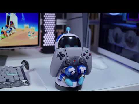 An Astrobot Cable Guy figure standing upright with its robotic arms extended to hold a controller or device. The character has a white body with blue accents, a glossy black visor, and a compact display base inspired by the Astro Bot design.