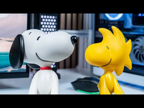 A Cable Guy figure of Snoopy standing upright with both paws extended to support a controller or device.